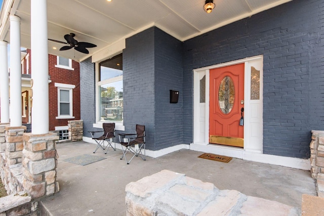 entrance to property with ceiling fan and covered porch