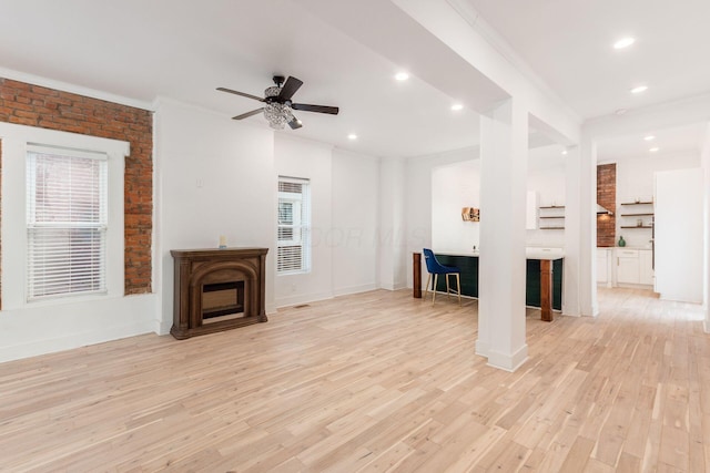 unfurnished living room featuring ceiling fan, light hardwood / wood-style floors, and crown molding