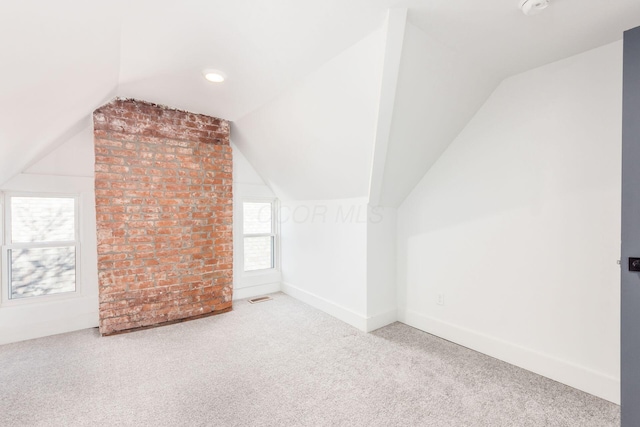 additional living space featuring carpet and vaulted ceiling