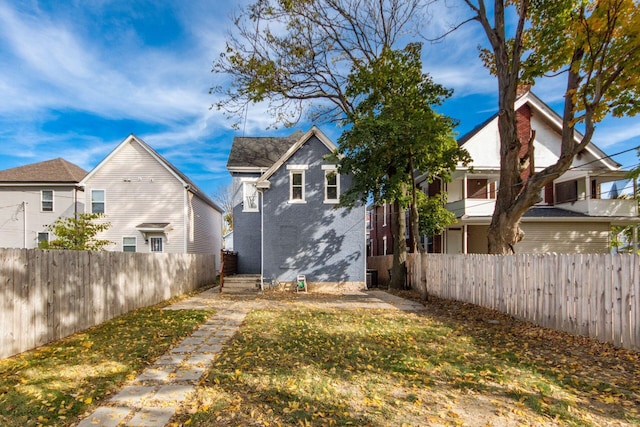 back of property featuring a lawn