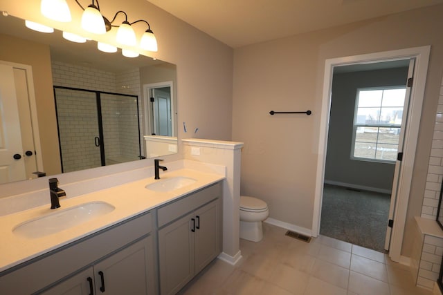 full bath featuring double vanity, a stall shower, a sink, and visible vents