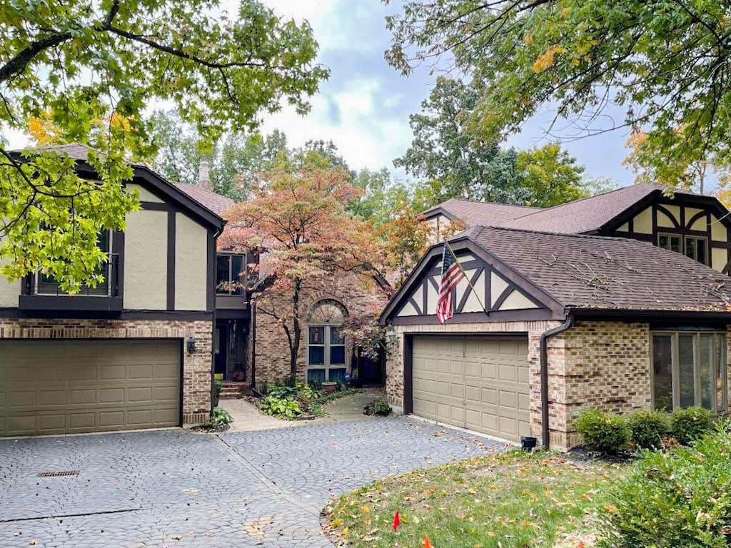 english style home featuring a garage