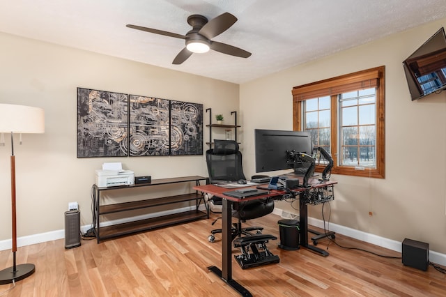 home office featuring ceiling fan and light hardwood / wood-style flooring