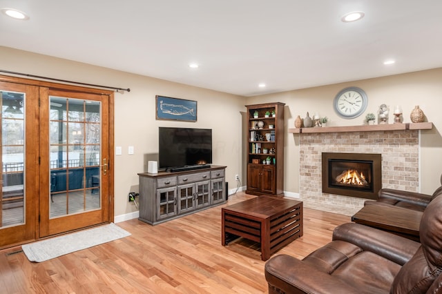 living room featuring a fireplace and light wood-type flooring