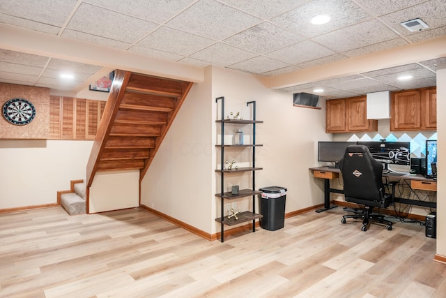 office featuring a paneled ceiling and light wood-type flooring