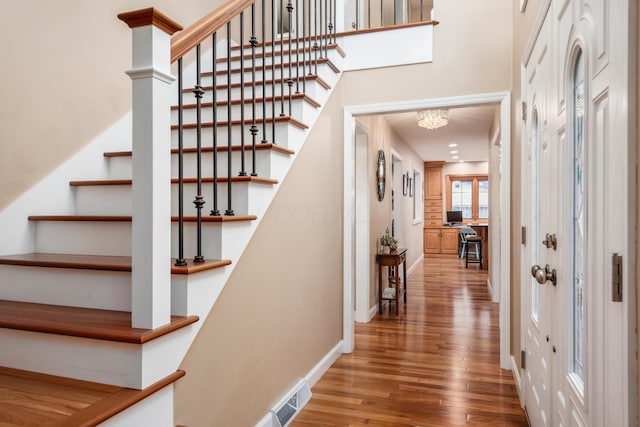 stairs featuring hardwood / wood-style floors