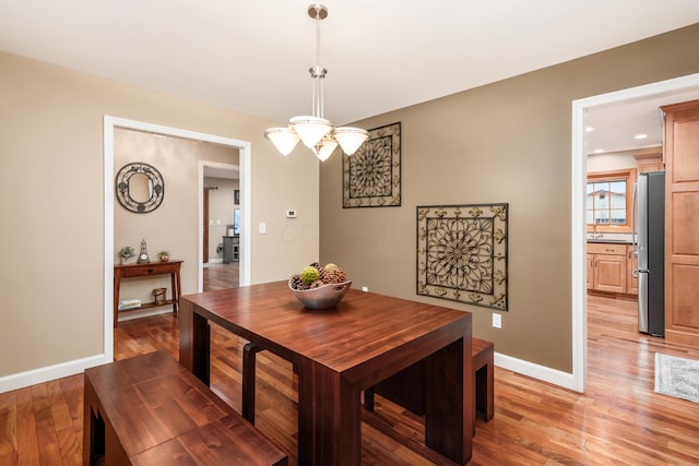 dining space with light wood-type flooring