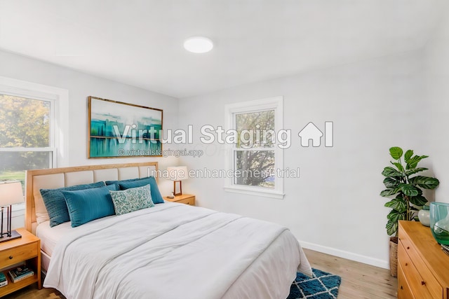 bedroom featuring light hardwood / wood-style floors and multiple windows