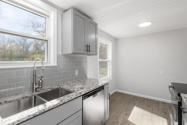 1961 Dartmouth Ave, Columbus, OH 43219 - kitchen featuring stainless steel appliances, decorative backsplash, wood finished floors, light stone counters, and gray cabinets