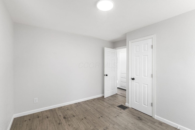 1961 Dartmouth Ave, Columbus, OH 43219 - unfurnished bedroom featuring baseboards and wood finished floors