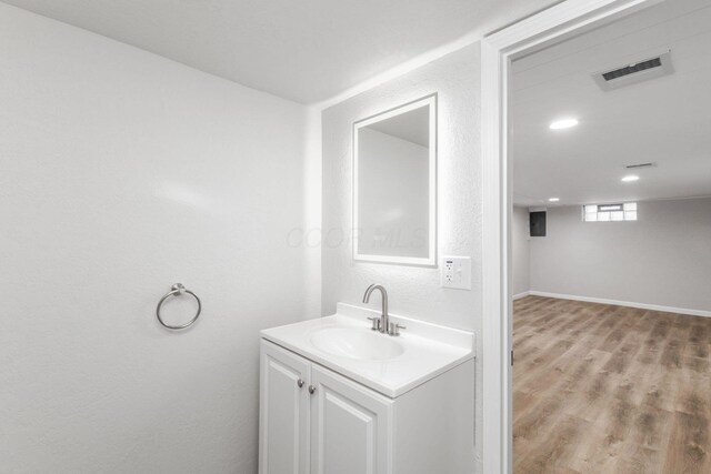 1961 Dartmouth Ave, Columbus, OH 43219 - bathroom featuring vanity, wood finished floors, recessed lighting, and a textured wall