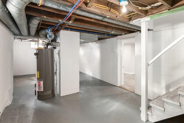 1961 Dartmouth Ave, Columbus, OH 43219 - below grade area featuring water heater, stairway, and concrete block wall