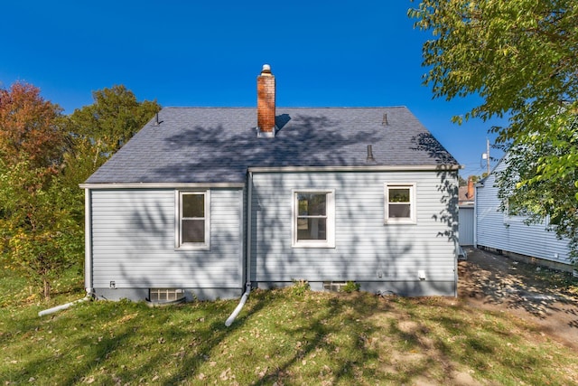 1961 Dartmouth Ave, Columbus, OH 43219 - back of house with a chimney and a lawn