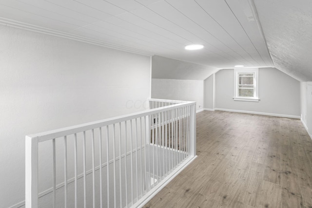 additional living space with wood-type flooring and lofted ceiling