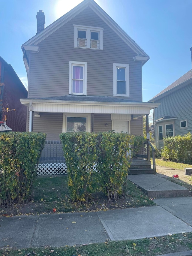 view of property featuring covered porch