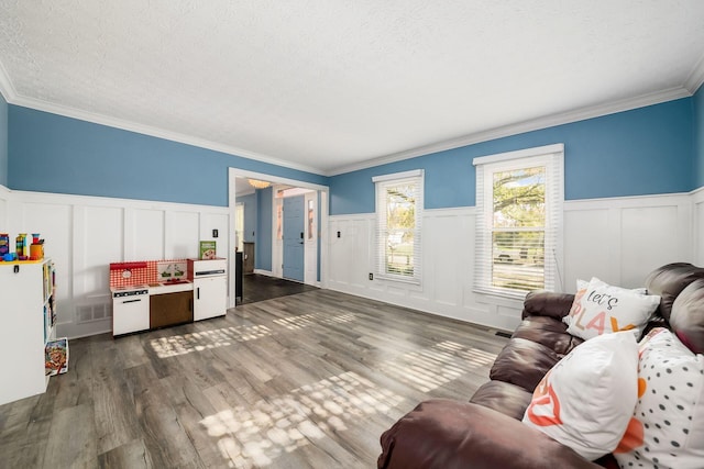 living room with a textured ceiling, dark hardwood / wood-style floors, and crown molding