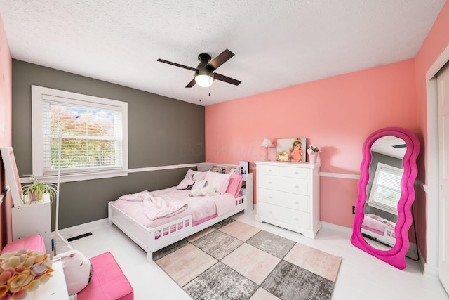 bedroom with a textured ceiling and ceiling fan