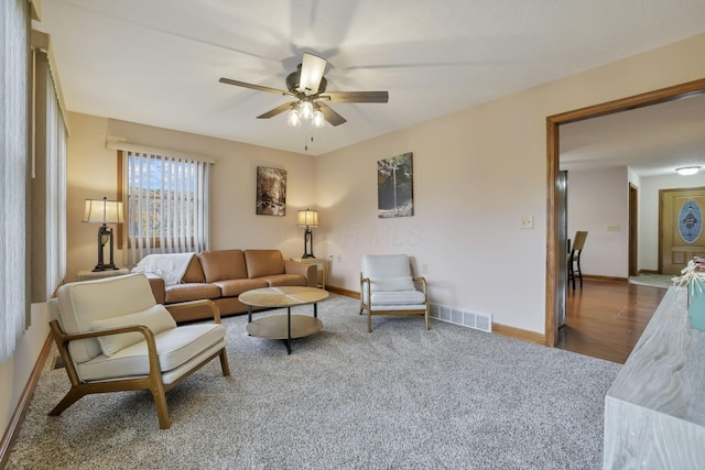 living room featuring ceiling fan and hardwood / wood-style flooring