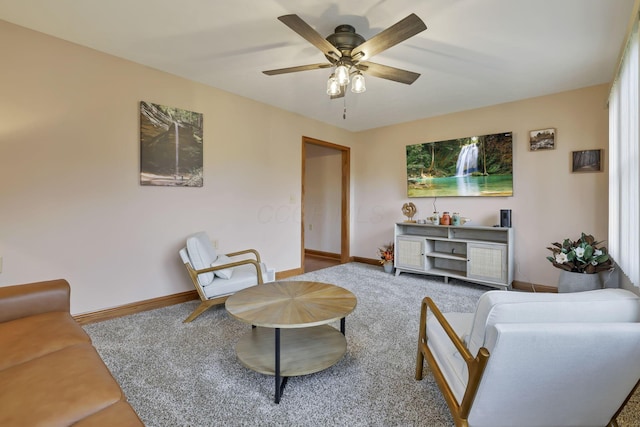 carpeted living room with ceiling fan