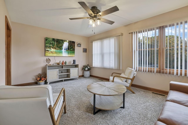 carpeted living room featuring ceiling fan