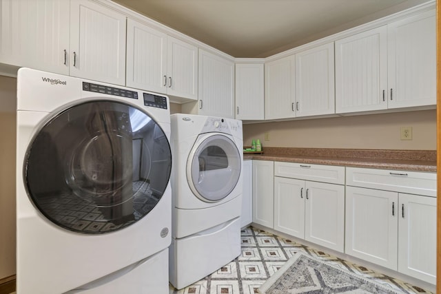 laundry room with cabinets and washing machine and dryer