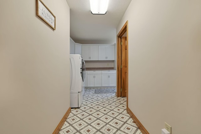 hallway with washer / clothes dryer and a textured ceiling