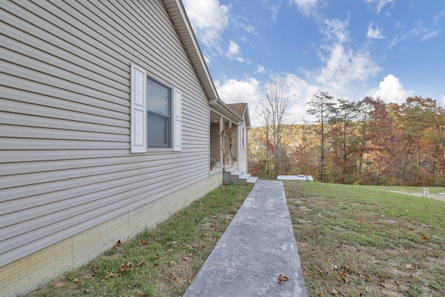 view of side of property with a lawn