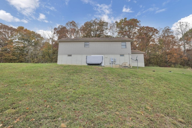 rear view of house featuring a yard