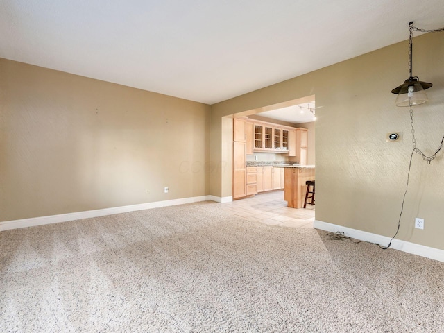 unfurnished living room with light carpet