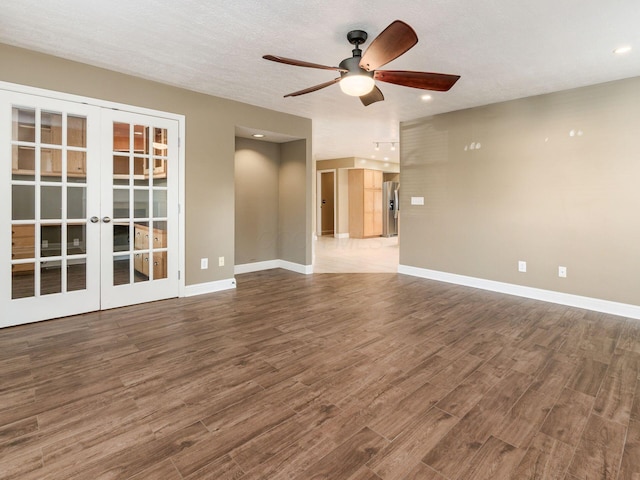 unfurnished living room with french doors, ceiling fan, a textured ceiling, and hardwood / wood-style flooring