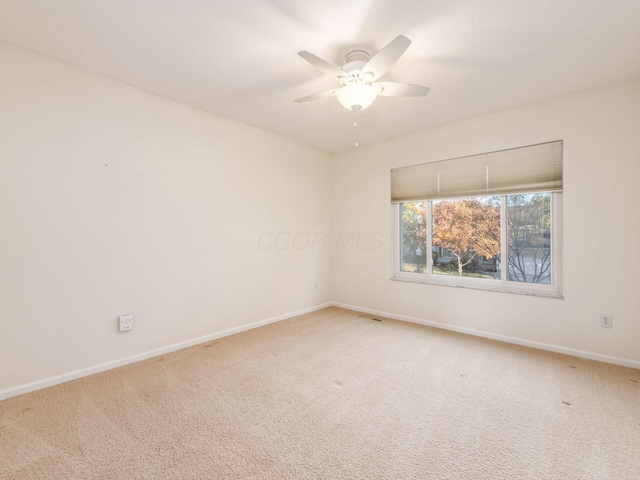 spare room featuring carpet and ceiling fan