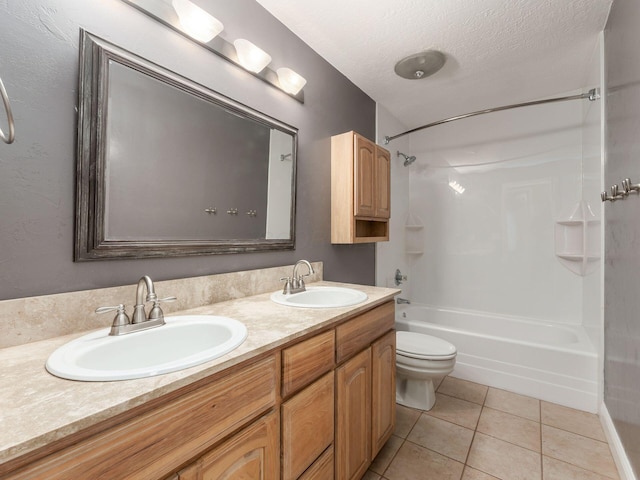 full bathroom with bathing tub / shower combination, vanity, a textured ceiling, tile patterned floors, and toilet