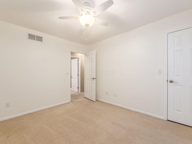 carpeted empty room with ceiling fan