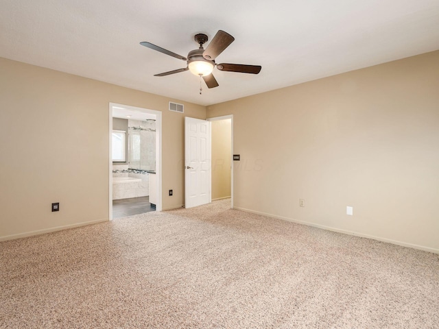 unfurnished bedroom with ensuite bath, carpet floors, and ceiling fan