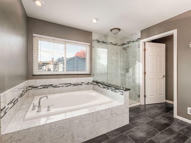 bathroom featuring separate shower and tub