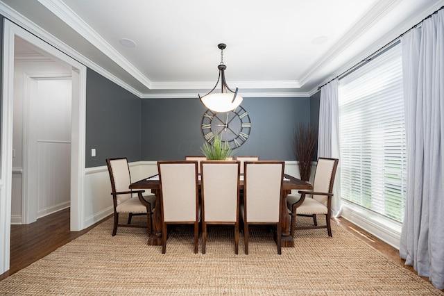 dining room featuring wood-type flooring and crown molding