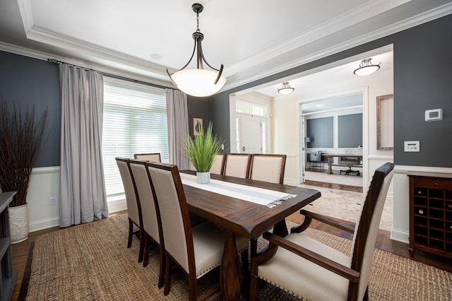 dining area featuring hardwood / wood-style floors and ornamental molding