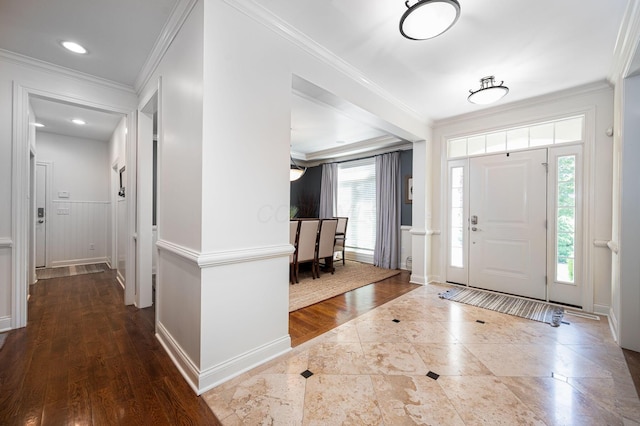 foyer with hardwood / wood-style flooring and ornamental molding