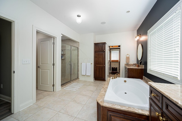 bathroom with tile patterned flooring, vanity, and plus walk in shower