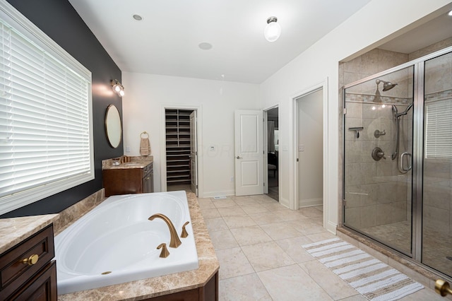 bathroom featuring tile patterned floors, vanity, and plus walk in shower