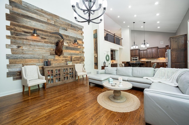 living room featuring high vaulted ceiling, dark hardwood / wood-style floors, and wooden walls