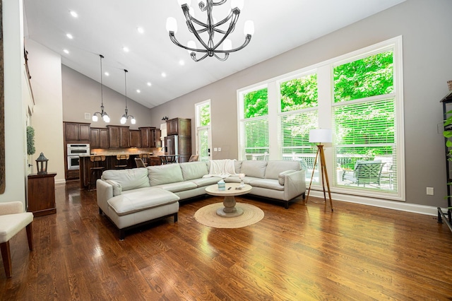 living room with high vaulted ceiling, dark hardwood / wood-style floors, and a notable chandelier