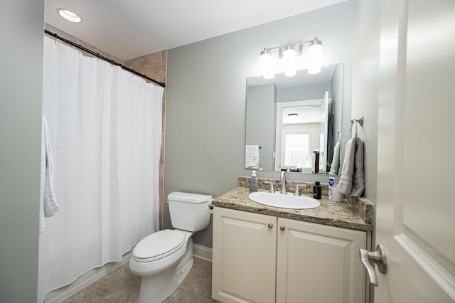 bathroom with tile patterned flooring, vanity, and toilet