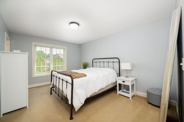 bedroom featuring light colored carpet