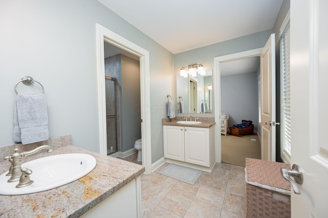 bathroom with tile patterned flooring, vanity, and toilet