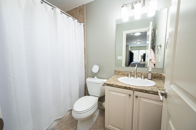 bathroom featuring tile patterned floors, vanity, and toilet