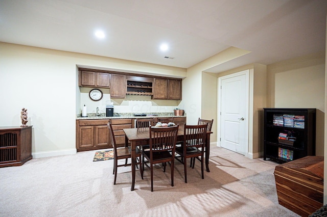 carpeted dining area featuring sink