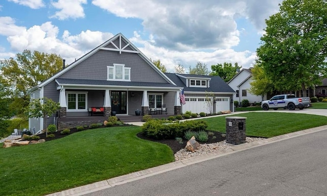 craftsman inspired home featuring covered porch and a front yard