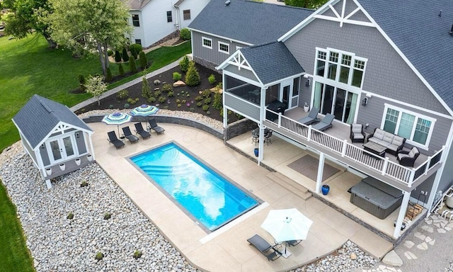 rear view of house featuring outdoor lounge area and a patio area