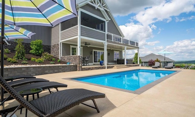 view of pool with a patio area, ceiling fan, and a jacuzzi